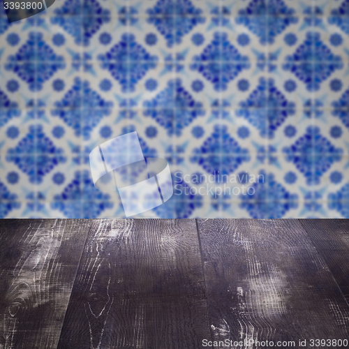 Image of Wood table top and blur vintage ceramic tile pattern wall
