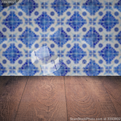 Image of Wood table top and blur vintage ceramic tile pattern wall