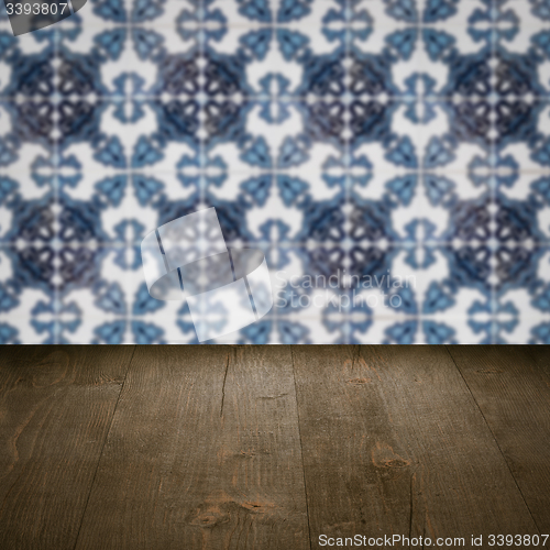 Image of Wood table top and blur vintage ceramic tile pattern wall