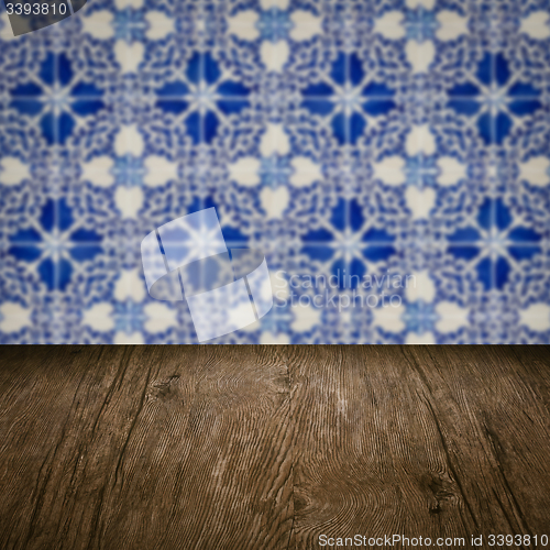 Image of Wood table top and blur vintage ceramic tile pattern wall