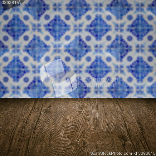 Image of Wood table top and blur vintage ceramic tile pattern wall