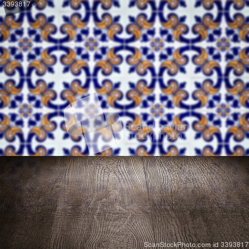 Image of Wood table top and blur vintage ceramic tile pattern wall