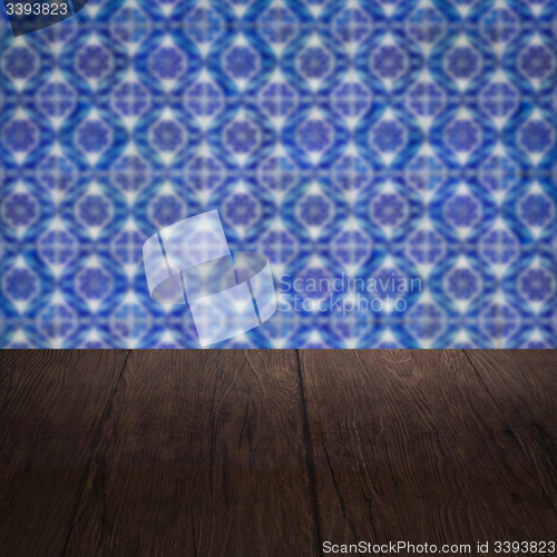 Image of Wood table top and blur vintage ceramic tile pattern wall