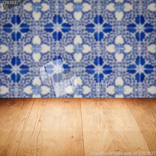 Image of Wood table top and blur vintage ceramic tile pattern wall