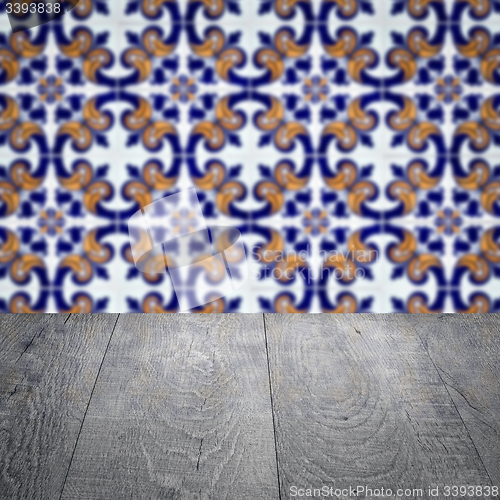 Image of Wood table top and blur vintage ceramic tile pattern wall