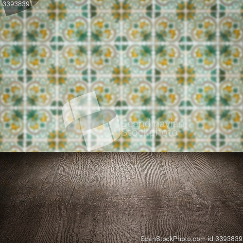 Image of Wood table top and blur vintage ceramic tile pattern wall