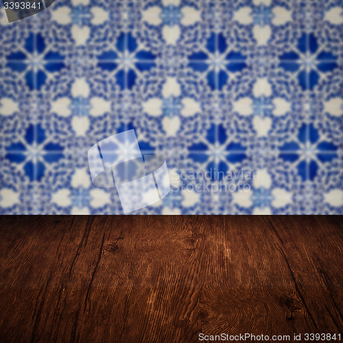 Image of Wood table top and blur vintage ceramic tile pattern wall