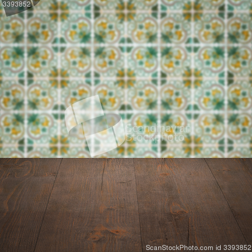 Image of Wood table top and blur vintage ceramic tile pattern wall