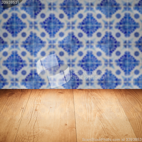 Image of Wood table top and blur vintage ceramic tile pattern wall