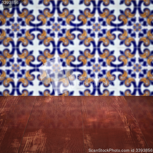 Image of Wood table top and blur vintage ceramic tile pattern wall