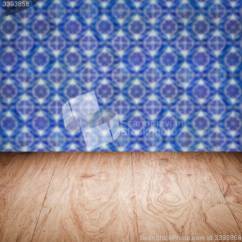 Image of Wood table top and blur vintage ceramic tile pattern wall