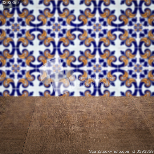 Image of Wood table top and blur vintage ceramic tile pattern wall