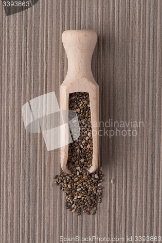 Image of Wooden scoop with chia seeds