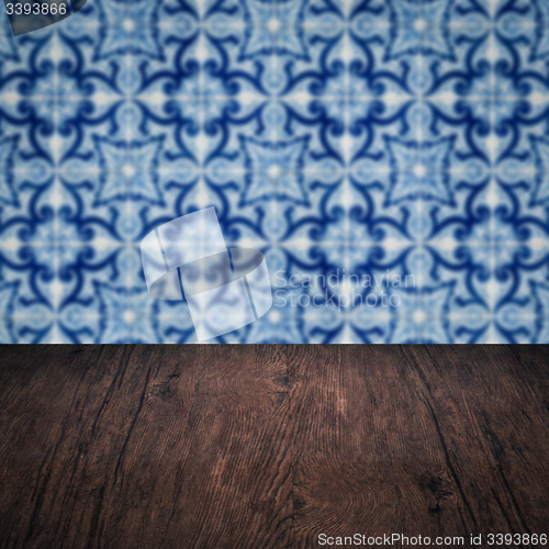 Image of Wood table top and blur vintage ceramic tile pattern wall