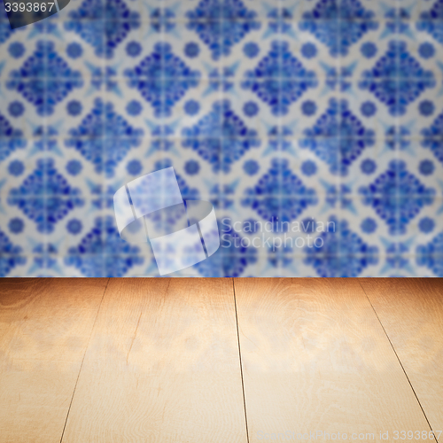 Image of Wood table top and blur vintage ceramic tile pattern wall