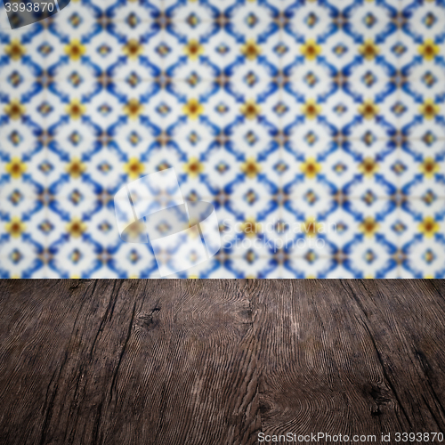 Image of Wood table top and blur vintage ceramic tile pattern wall