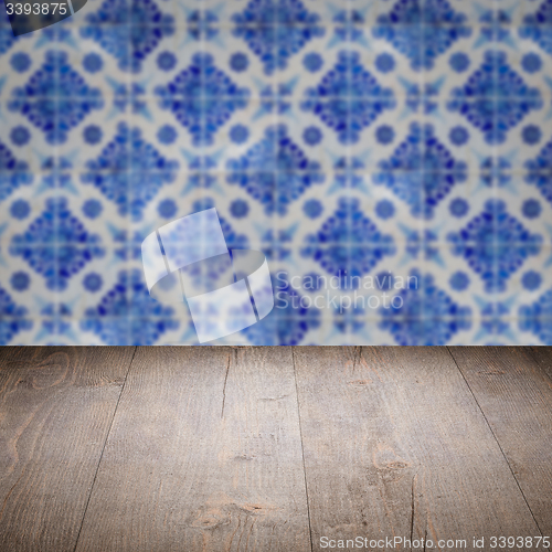 Image of Wood table top and blur vintage ceramic tile pattern wall