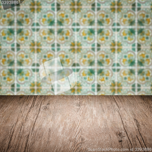 Image of Wood table top and blur vintage ceramic tile pattern wall
