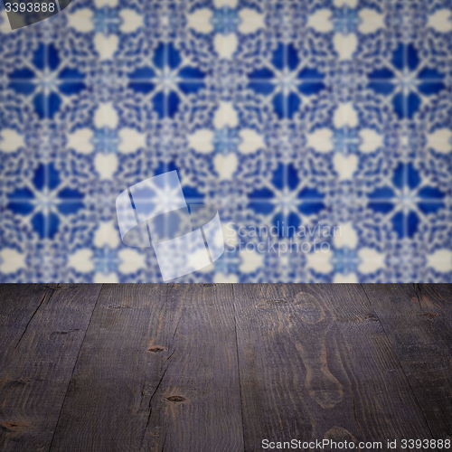 Image of Wood table top and blur vintage ceramic tile pattern wall