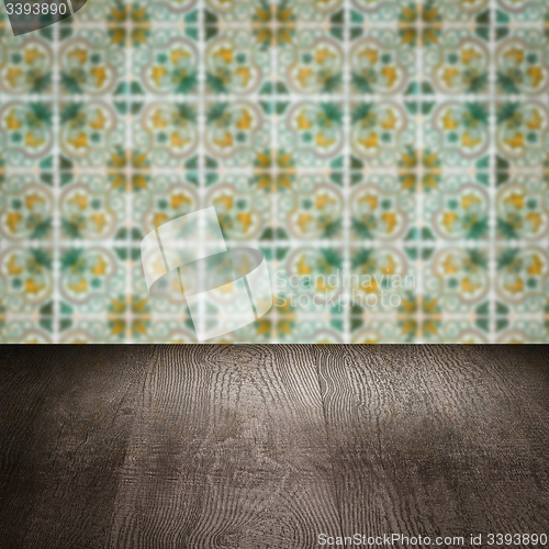 Image of Wood table top and blur vintage ceramic tile pattern wall