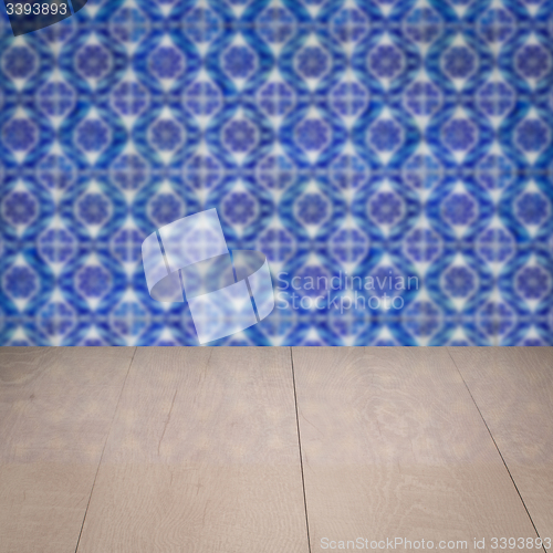 Image of Wood table top and blur vintage ceramic tile pattern wall
