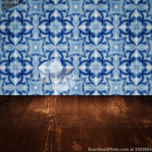 Image of Wood table top and blur vintage ceramic tile pattern wall