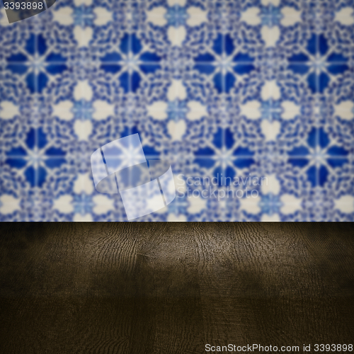 Image of Wood table top and blur vintage ceramic tile pattern wall
