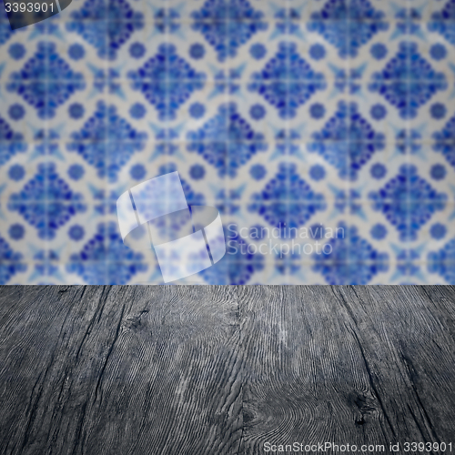 Image of Wood table top and blur vintage ceramic tile pattern wall