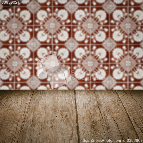Image of Wood table top and blur vintage ceramic tile pattern wall