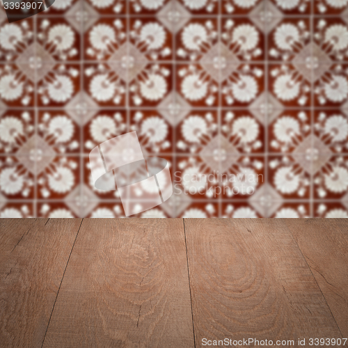 Image of Wood table top and blur vintage ceramic tile pattern wall