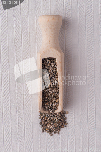 Image of Wooden scoop with chia seeds