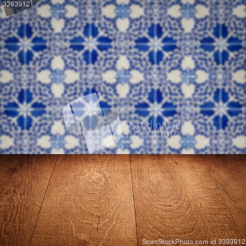 Image of Wood table top and blur vintage ceramic tile pattern wall