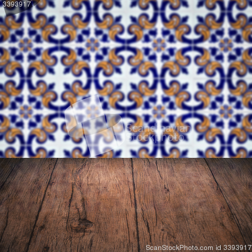 Image of Wood table top and blur vintage ceramic tile pattern wall