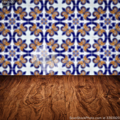 Image of Wood table top and blur vintage ceramic tile pattern wall