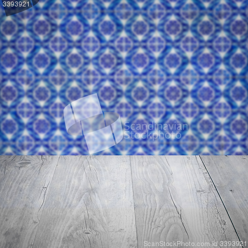 Image of Wood table top and blur vintage ceramic tile pattern wall