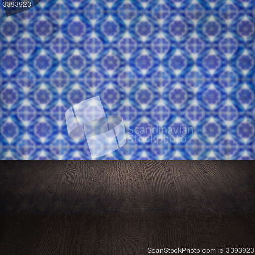 Image of Wood table top and blur vintage ceramic tile pattern wall