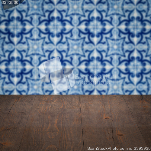 Image of Wood table top and blur vintage ceramic tile pattern wall