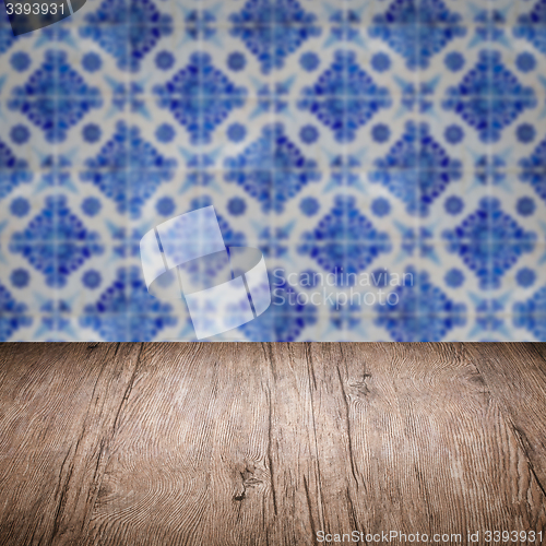 Image of Wood table top and blur vintage ceramic tile pattern wall