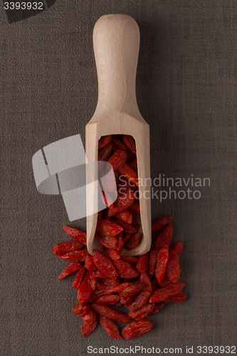 Image of Wooden scoop with dry red goji berries