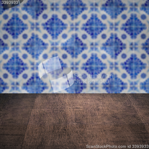 Image of Wood table top and blur vintage ceramic tile pattern wall