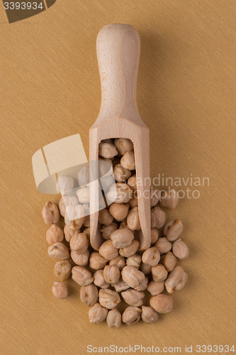 Image of Wooden scoop with chickpeas