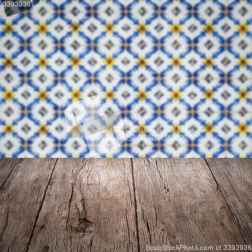 Image of Wood table top and blur vintage ceramic tile pattern wall