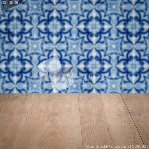 Image of Wood table top and blur vintage ceramic tile pattern wall