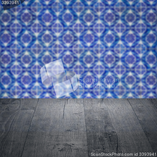 Image of Wood table top and blur vintage ceramic tile pattern wall