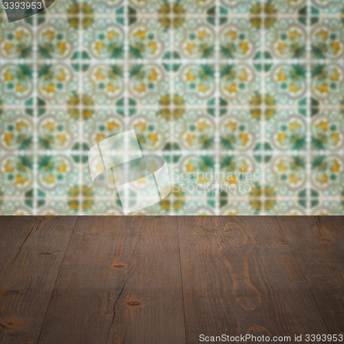 Image of Wood table top and blur vintage ceramic tile pattern wall