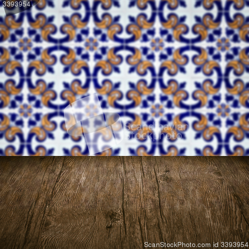 Image of Wood table top and blur vintage ceramic tile pattern wall