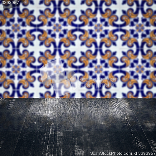 Image of Wood table top and blur vintage ceramic tile pattern wall