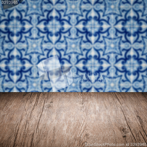 Image of Wood table top and blur vintage ceramic tile pattern wall