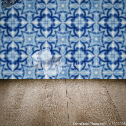 Image of Wood table top and blur vintage ceramic tile pattern wall