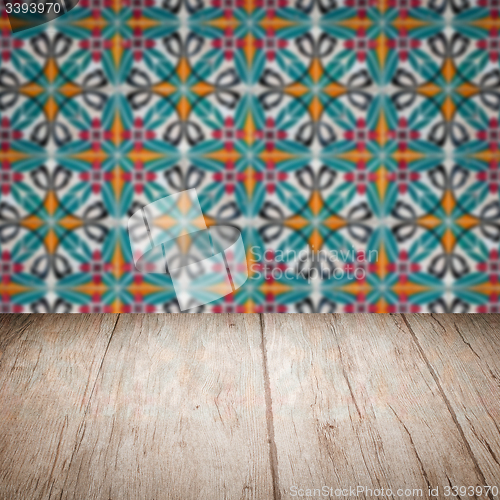 Image of Wood table top and blur vintage ceramic tile pattern wall